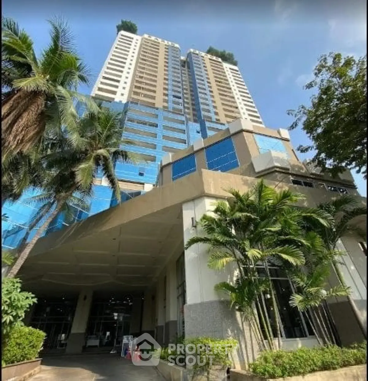 Stunning high-rise building with modern architecture and lush landscaping, perfect for urban living.