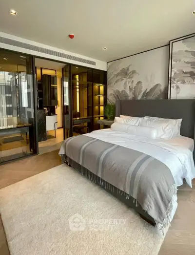 Luxurious bedroom with modern decor and large windows in upscale apartment.