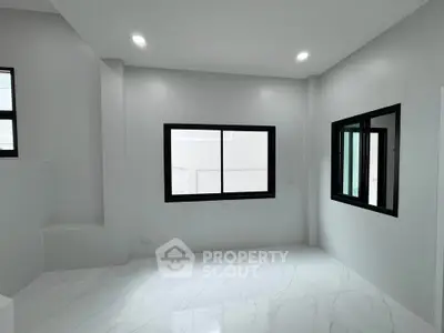 Modern minimalist room with large windows and sleek white flooring