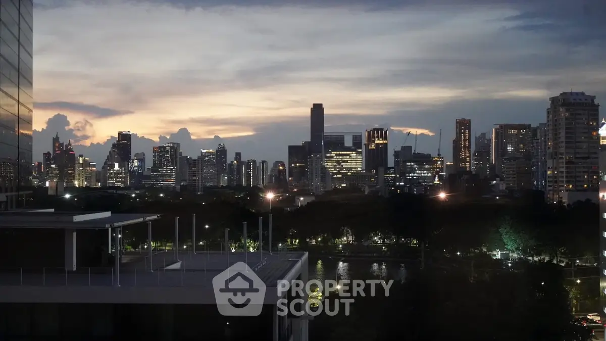 Stunning city skyline view at dusk with modern high-rise buildings and serene river.