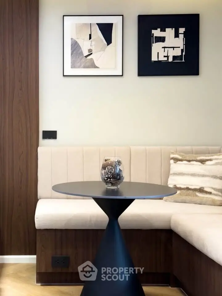 Stylish modern living room with elegant wall art and cozy seating area.