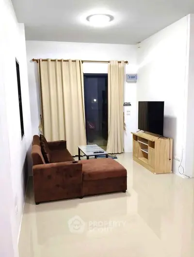 Modern living room with brown sectional sofa and flat-screen TV, perfect for relaxation.