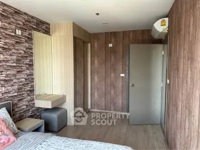 Modern bedroom with stylish wood paneling and mirrored wardrobe in a cozy apartment.