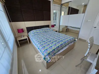 Modern bedroom with stylish decor and ample natural light