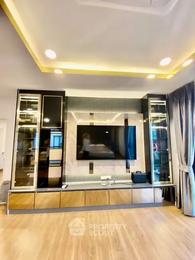 Luxurious living room with modern entertainment center and elegant lighting