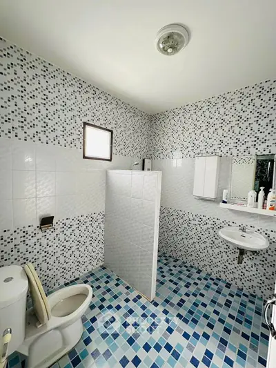 Spacious bathroom with modern mosaic tiles and sleek fixtures