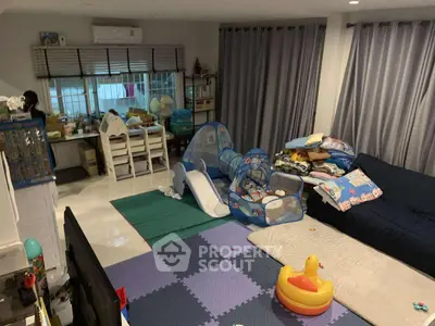 Spacious family living room with play area and cozy seating.