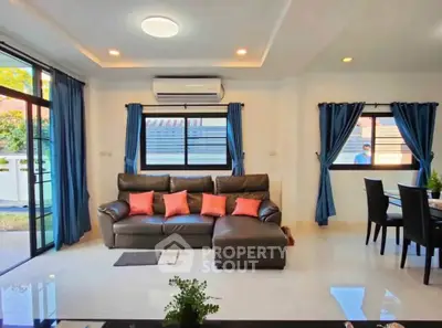 Spacious living room with modern decor and large windows for natural light