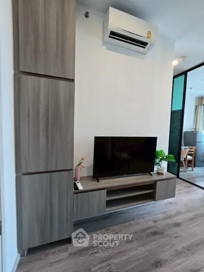 Modern living room with sleek TV unit and air conditioning