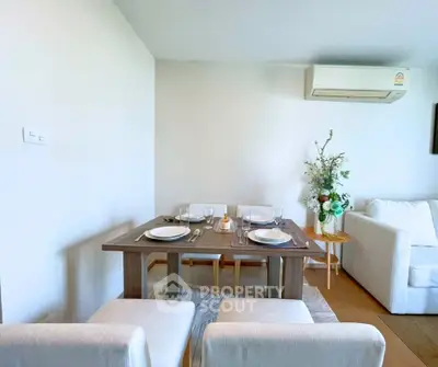 Chic dining area with modern table and cozy seating in a stylish apartment.