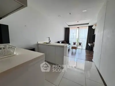 Modern open-layout living room with sleek kitchen and balcony view