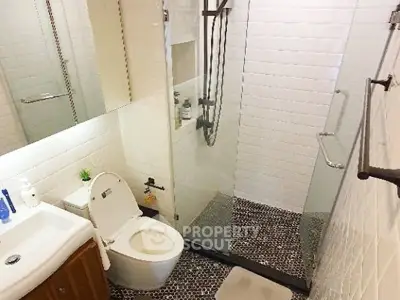 Modern bathroom with glass shower and stylish tile flooring