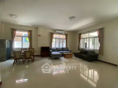 Spacious living room with modern furniture and large windows for natural light.