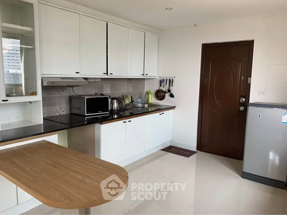 Modern kitchen with sleek white cabinets and stainless steel appliances