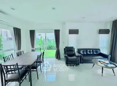 Spacious modern living room with garden view and elegant furniture