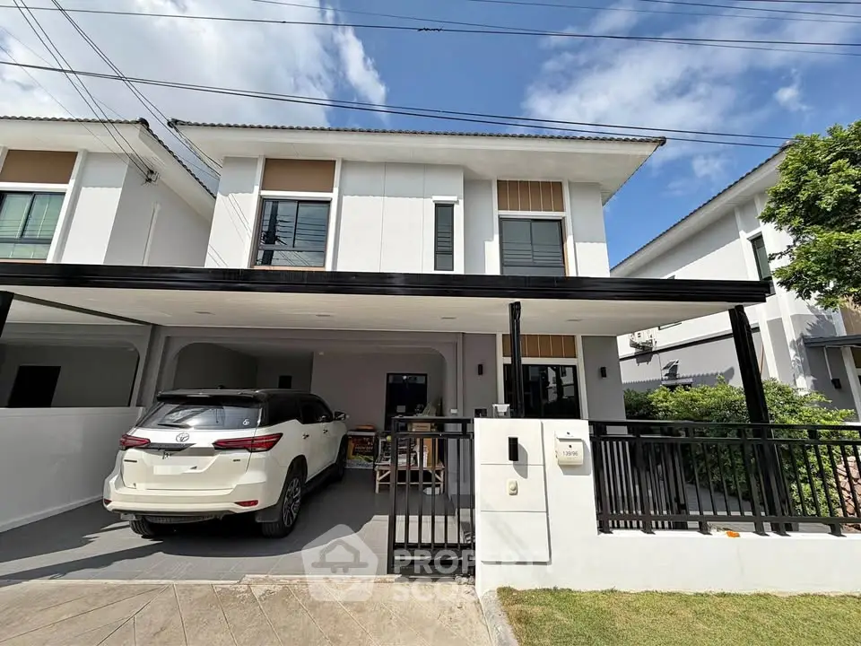 Modern two-story house with carport and landscaped front yard in a suburban neighborhood.