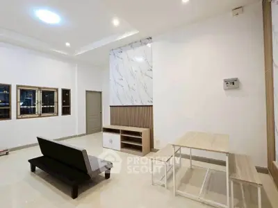Modern living room with minimalist furniture and marble accent wall