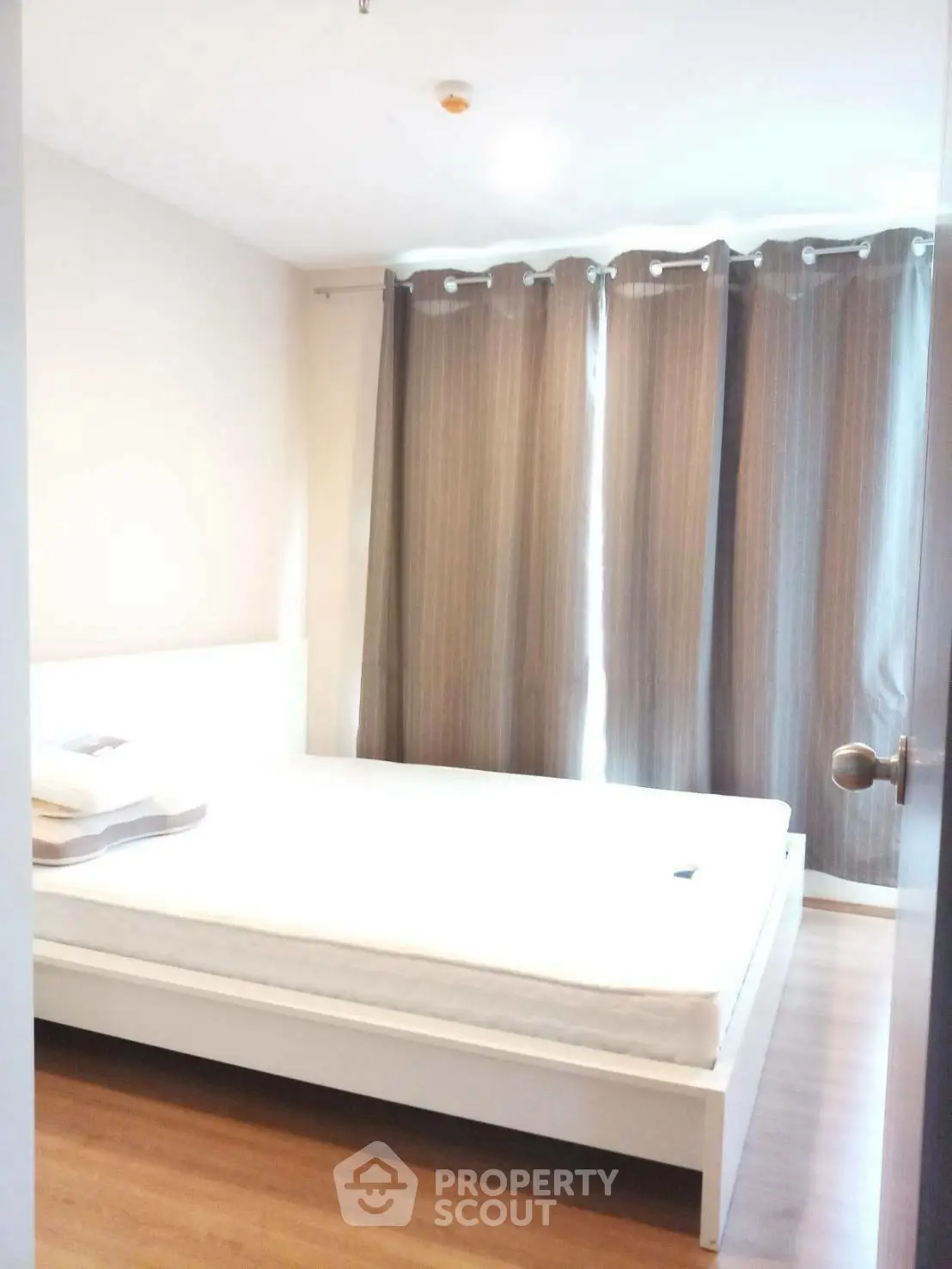 Spacious bedroom with natural light and modern decor in a stylish apartment.