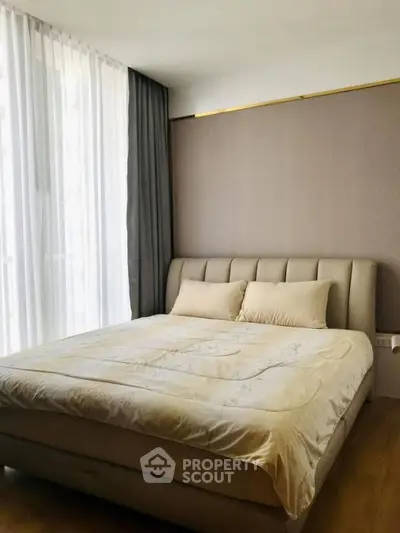Modern bedroom with elegant bed and soft lighting, perfect for relaxation and comfort.