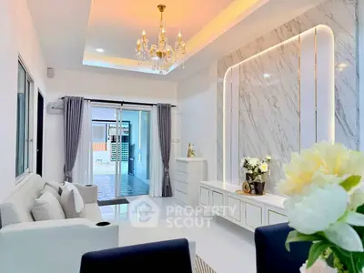 Elegant living room with chandelier and marble accent wall