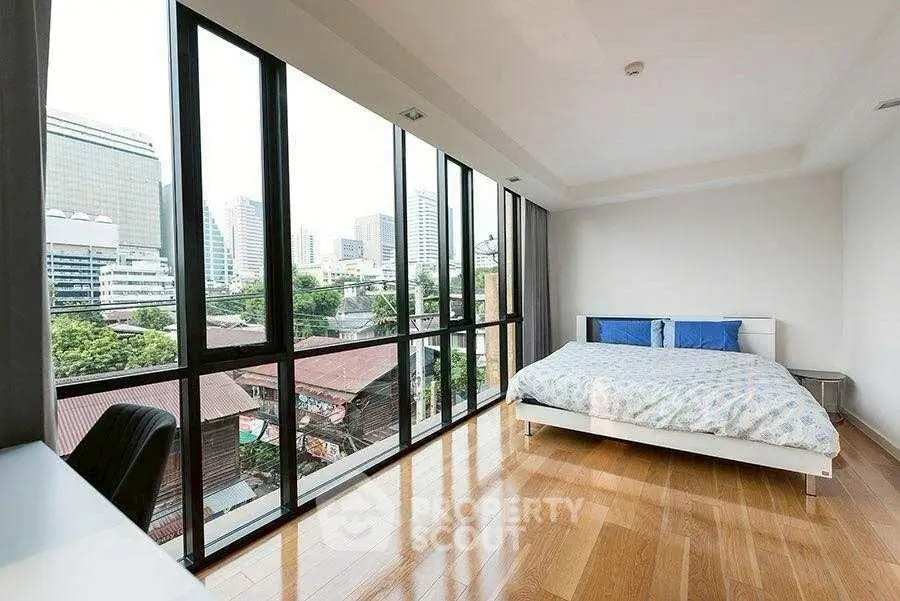 Spacious bedroom with panoramic city view and modern decor