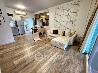 Spacious open-plan living room with modern decor and wooden flooring