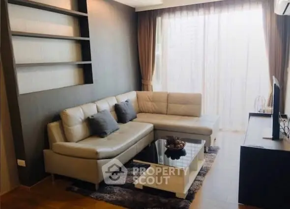 Modern living room with stylish sectional sofa and floor-to-ceiling windows