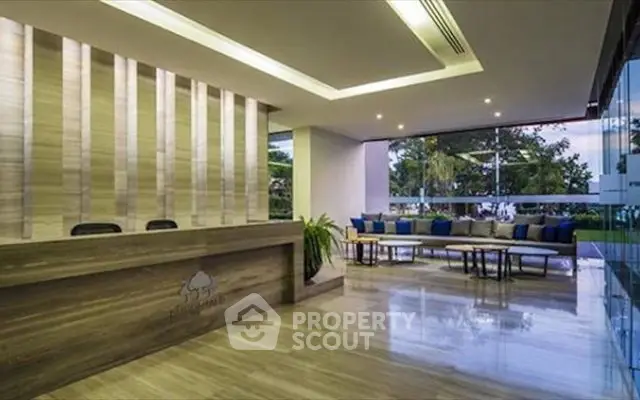 Luxurious modern lobby with elegant seating and garden view in upscale building.