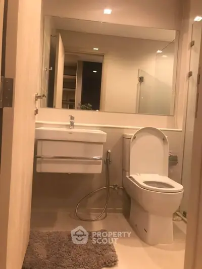 Modern bathroom with sleek fixtures and large mirror