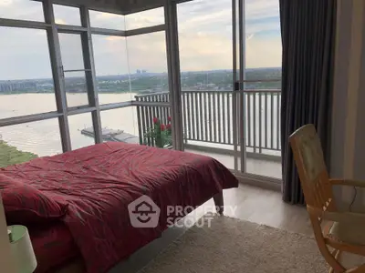 Stunning bedroom with panoramic river view and large windows for natural light.