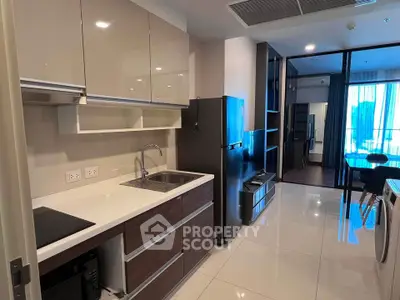 Modern kitchen with sleek cabinetry and appliances in a stylish apartment