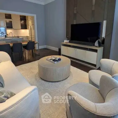 Elegant living room with modern furniture and open kitchen layout