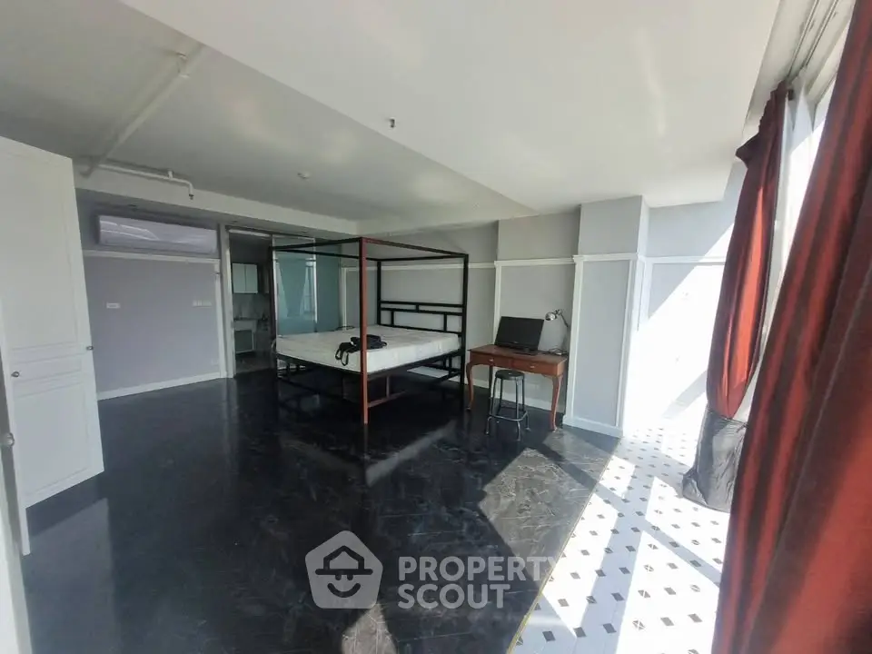 Spacious modern bedroom with large windows and natural light