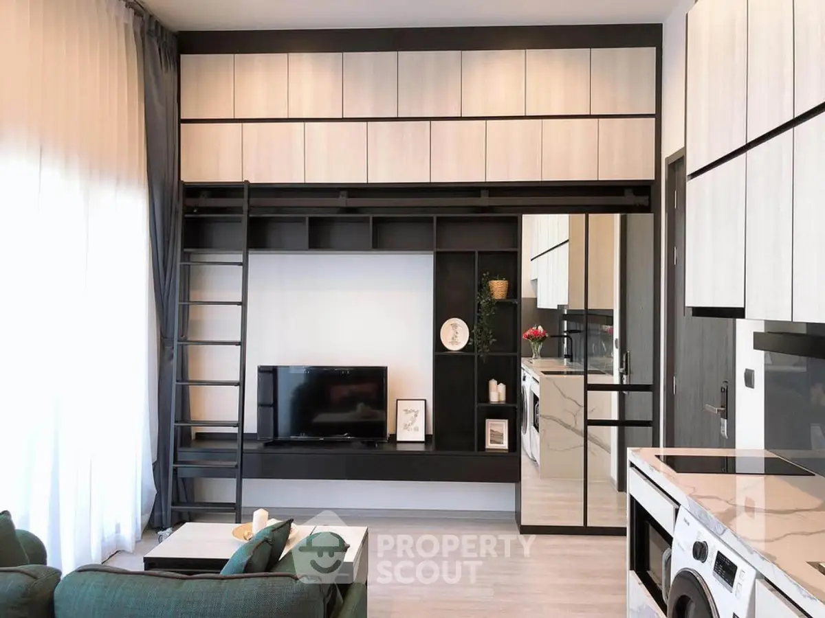 Modern living room with sleek storage, TV, and washing machine in stylish apartment.