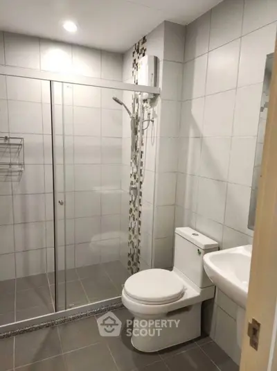 Modern bathroom with glass shower and sleek fixtures