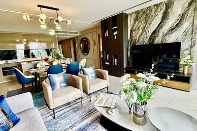 Luxurious modern living room with elegant decor and open kitchen layout, perfect for stylish urban living.