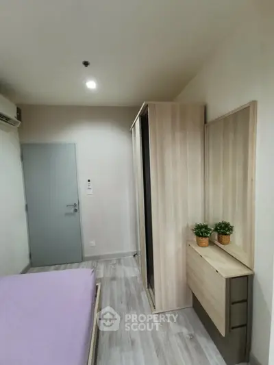 Modern bedroom with sleek wardrobe and minimalist decor