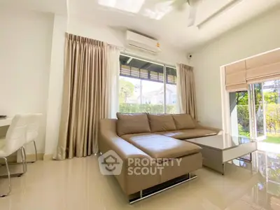 Spacious modern living room with large windows and garden view