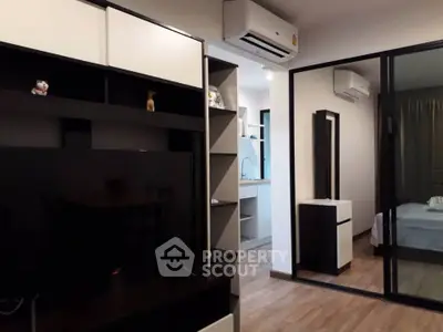 Modern apartment interior with sleek design and air conditioning, featuring a cozy living area and bedroom.