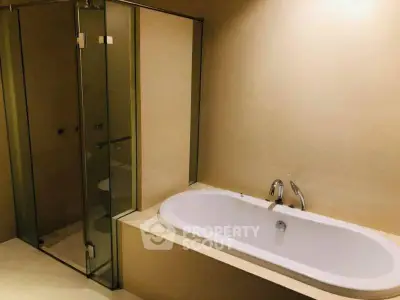 Luxurious bathroom with elegant bathtub and glass-enclosed shower, perfect for relaxation.