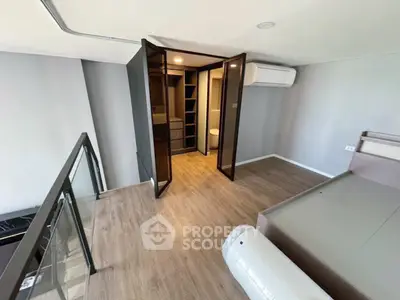 Modern bedroom with glass doors and wooden flooring in a stylish apartment