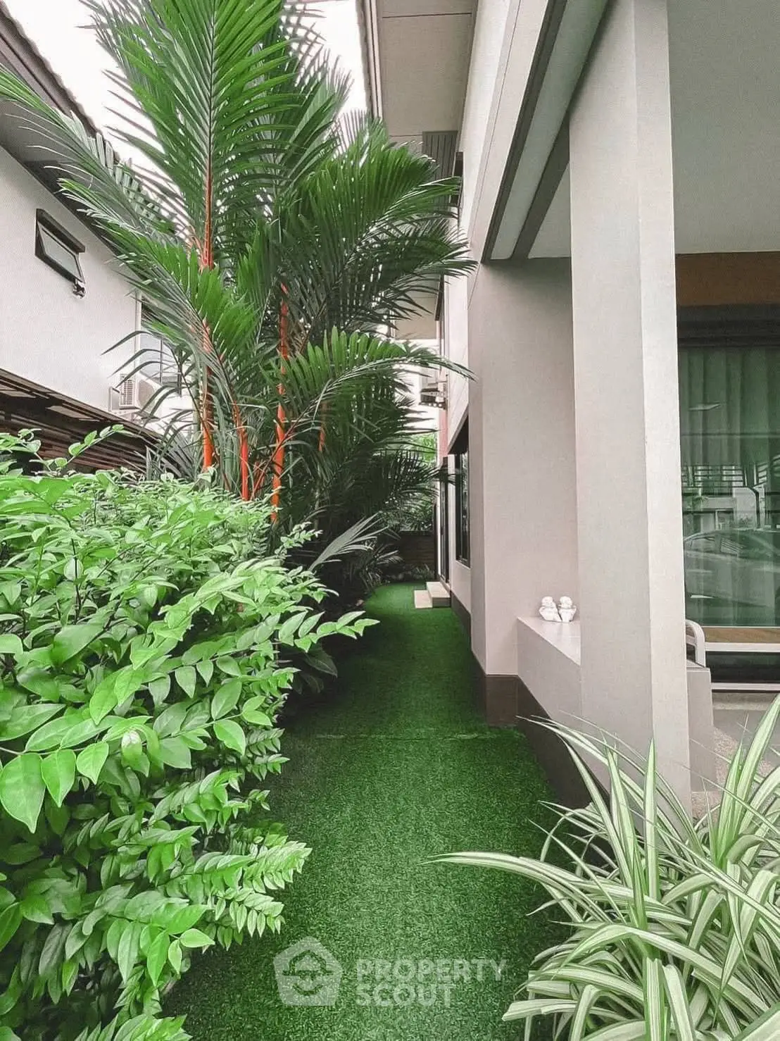 Lush garden pathway with modern exterior, perfect for serene outdoor living.