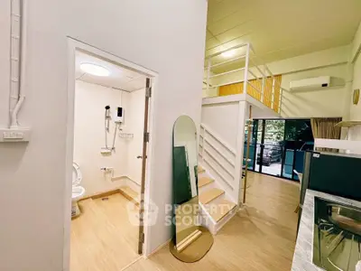 Modern loft apartment with open layout, featuring a stylish bathroom and spacious living area.
