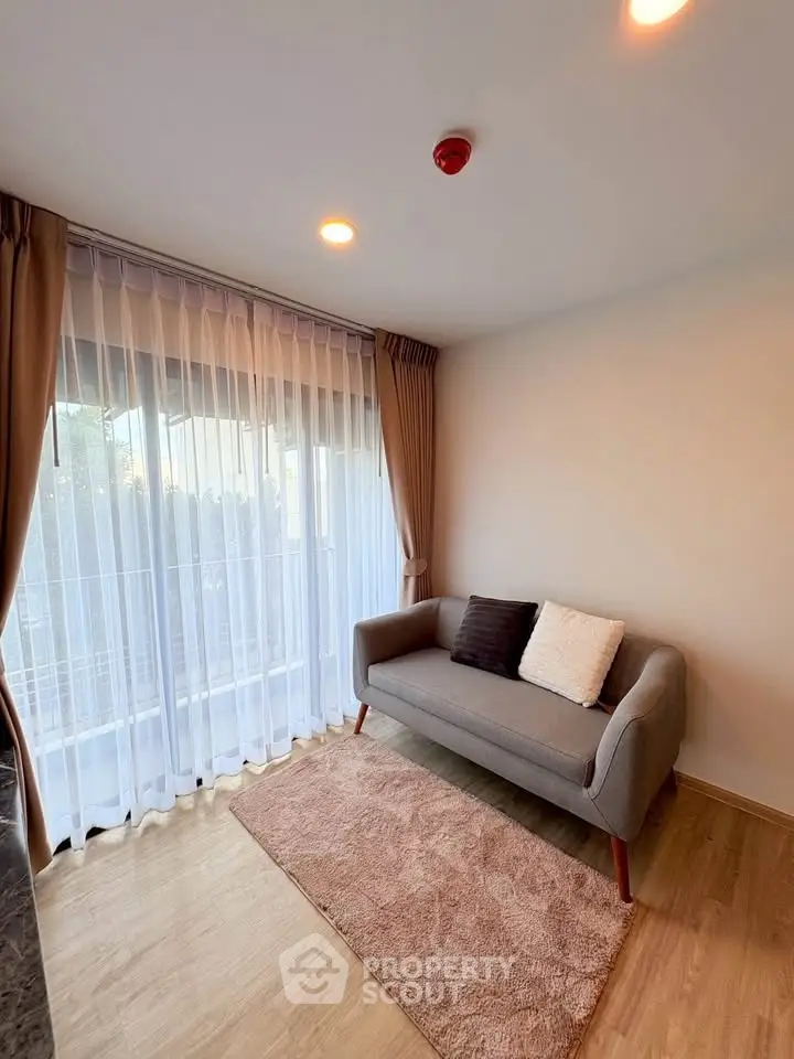 Cozy living room with modern sofa and large window for natural light