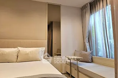 Cozy bedroom with modern decor and large window seating area