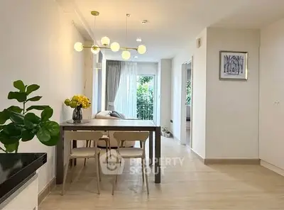 Modern dining area with elegant lighting and balcony view in a stylish apartment.
