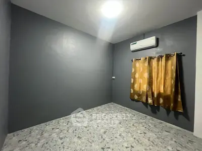Spacious empty room with air conditioning and modern gray walls