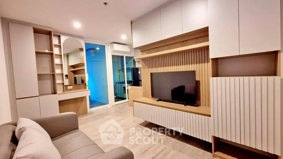 Modern living room with sleek cabinetry and stylish decor