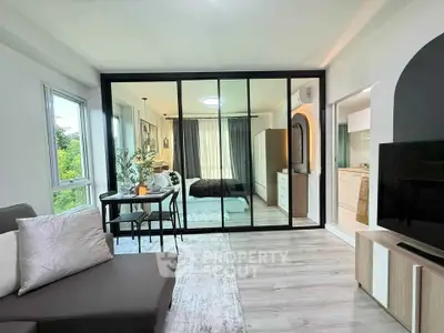 Modern open-plan living room with glass partition and stylish decor