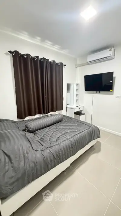 Modern bedroom with sleek design, featuring a wall-mounted TV and air conditioning for ultimate comfort.